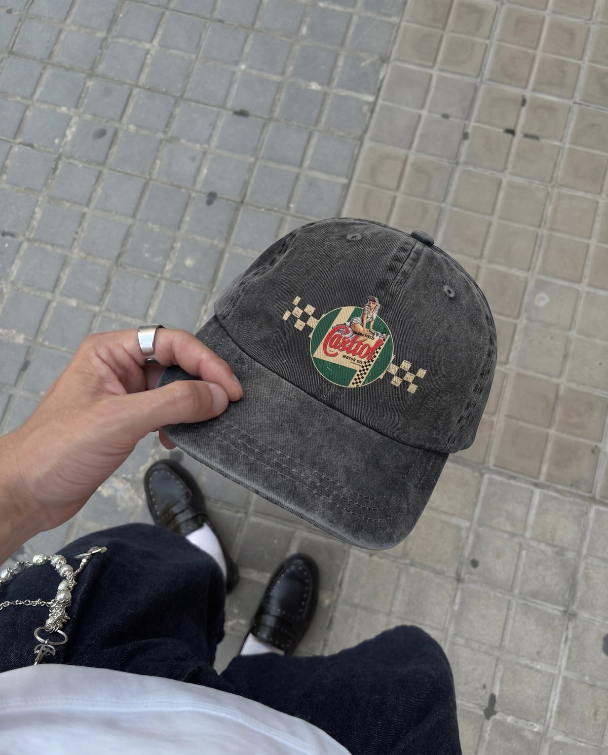 Hand holding the gray Castrol Motor embroidered cap