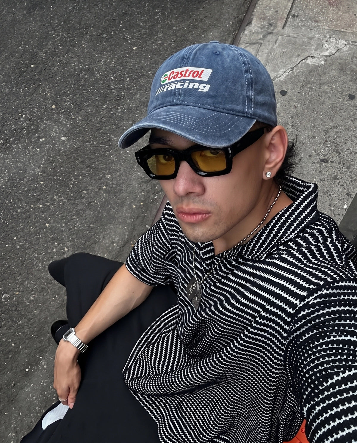 Blue Castrol Racing cap worn with sunglasses