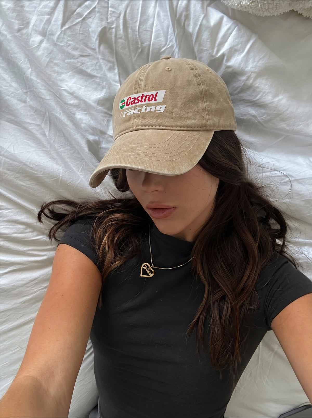 Beige Castrol Racing cap worn at home