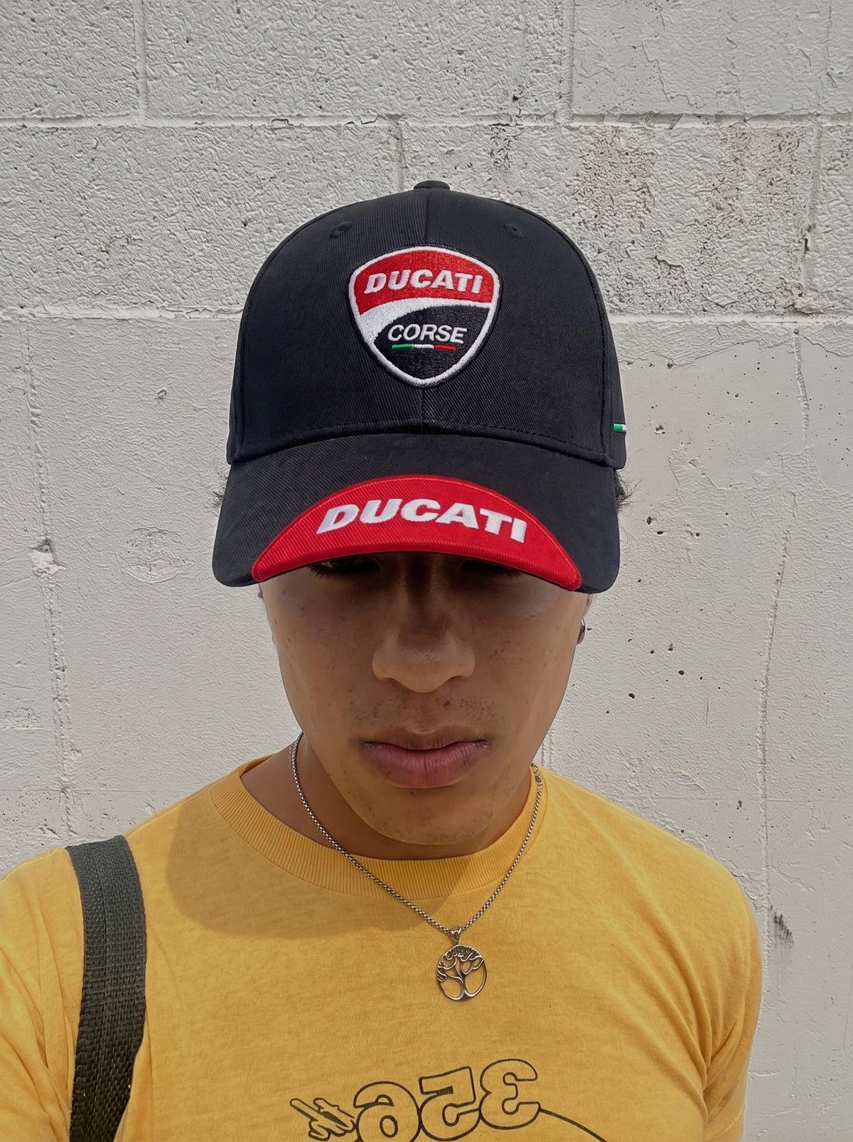 Model wearing the black Ducati Corse racing cap