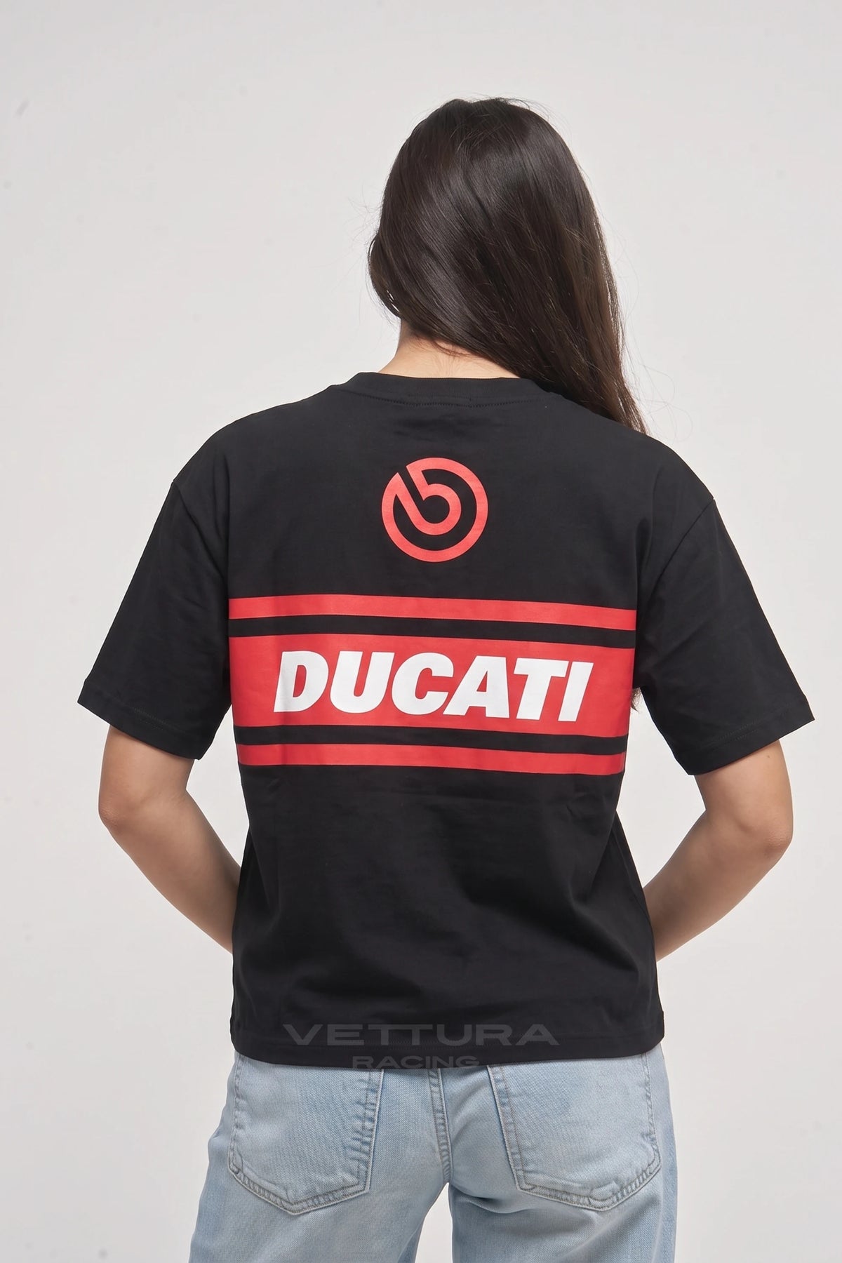 Woman wearing the Ducati racing tee, back view with the red Ducati band and shield