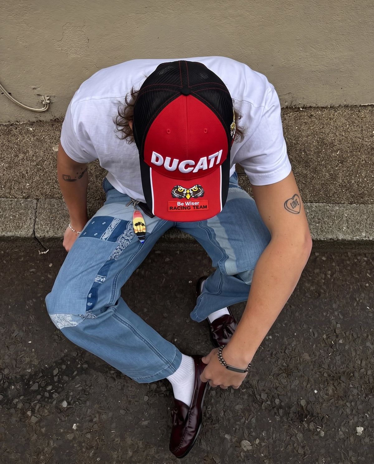 Model wearing the red Ducati Racing Team cap