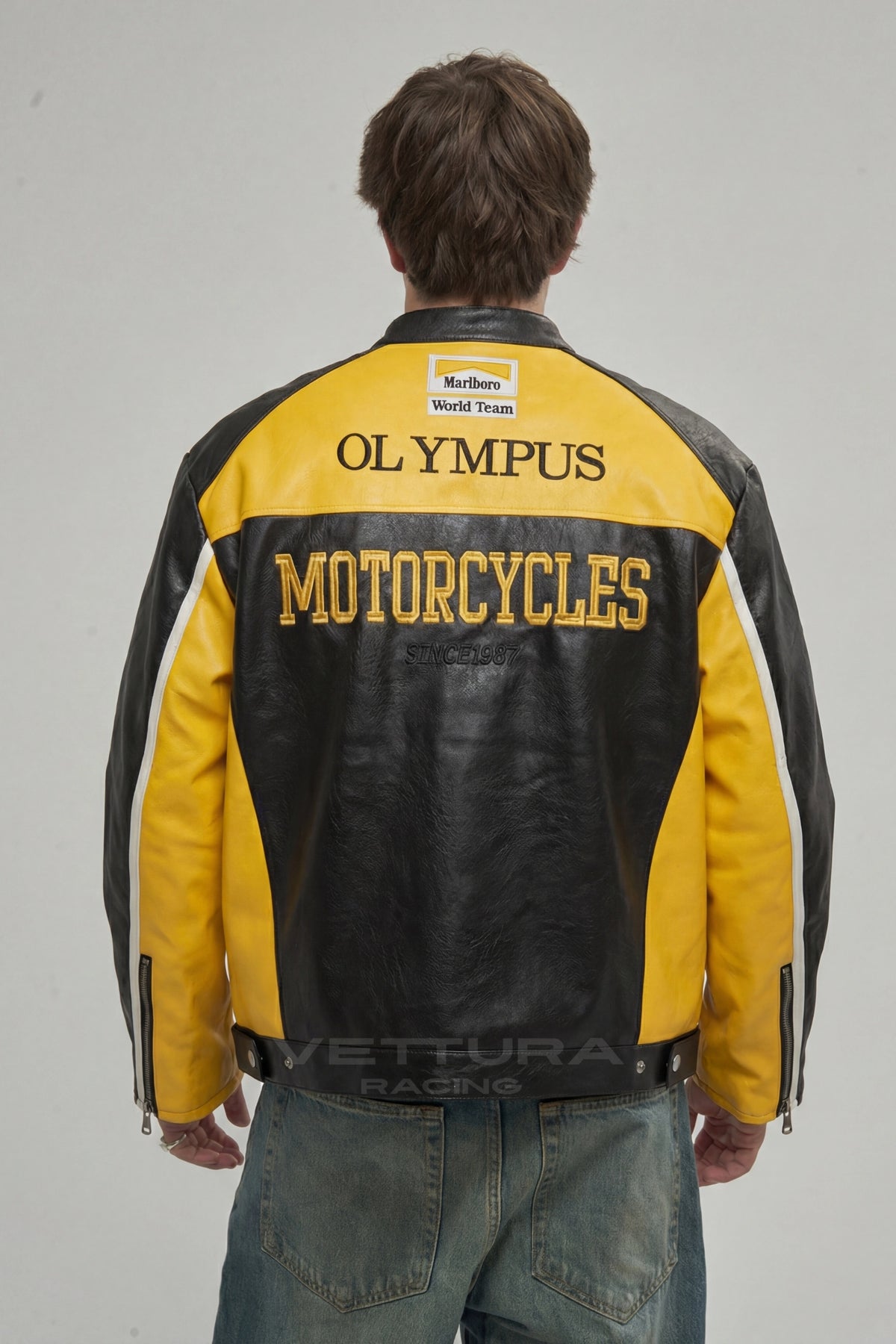 Close view of the Shell and Olympus patches on the yellow Ferrari jacket