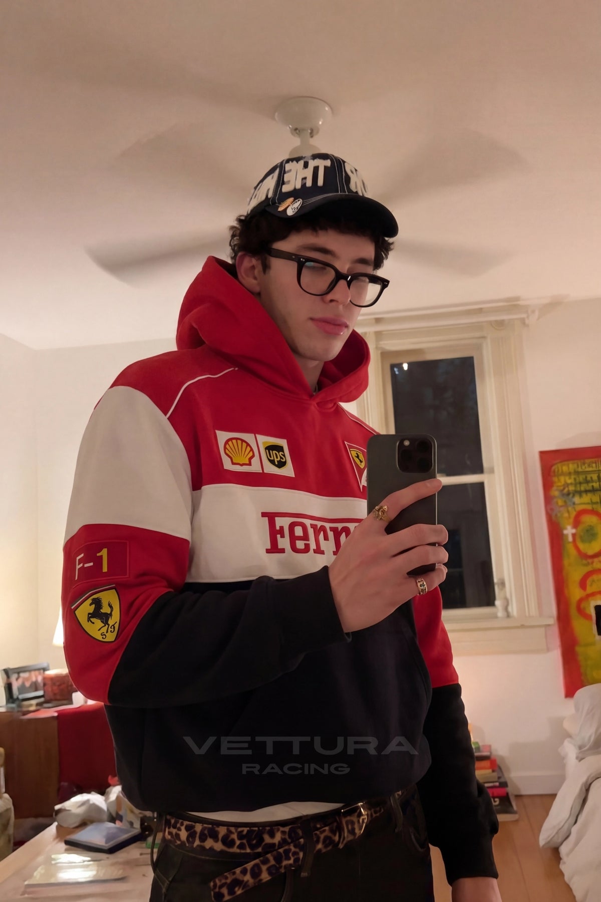 Close view of the embroidered Shell and Scuderia patches on the Ferrari hoodie