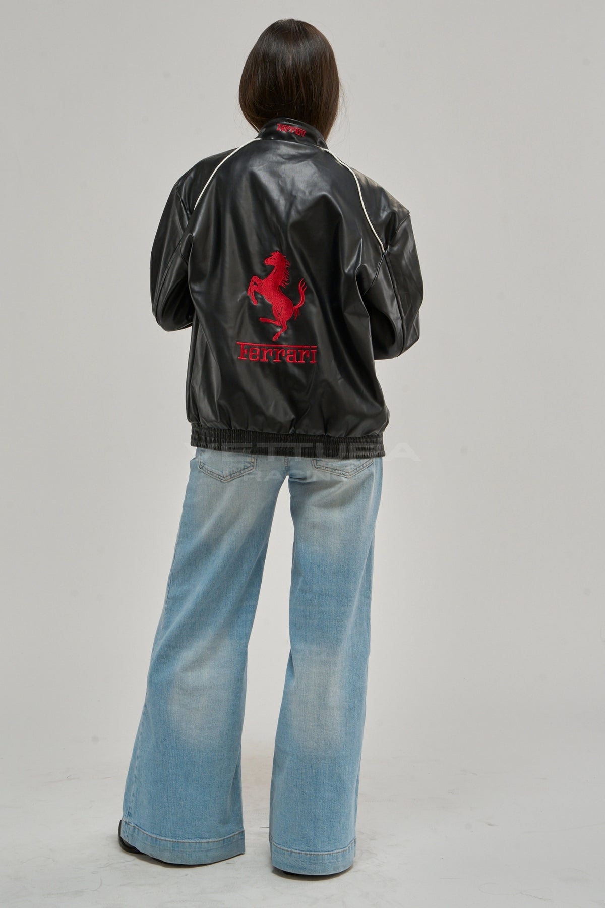 Ferrari F1 vegan leather jacket on a model, studio shot showing the embroidered patches