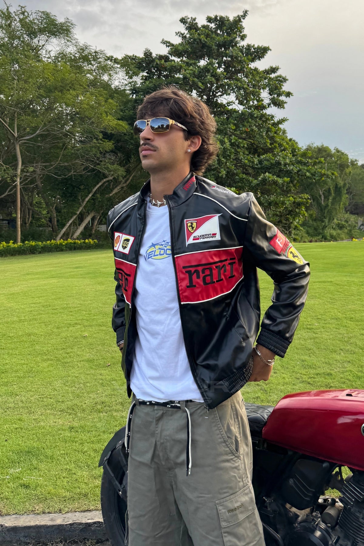 Ferrari F1 red leather racing jacket photographed outdoors, everyday styling