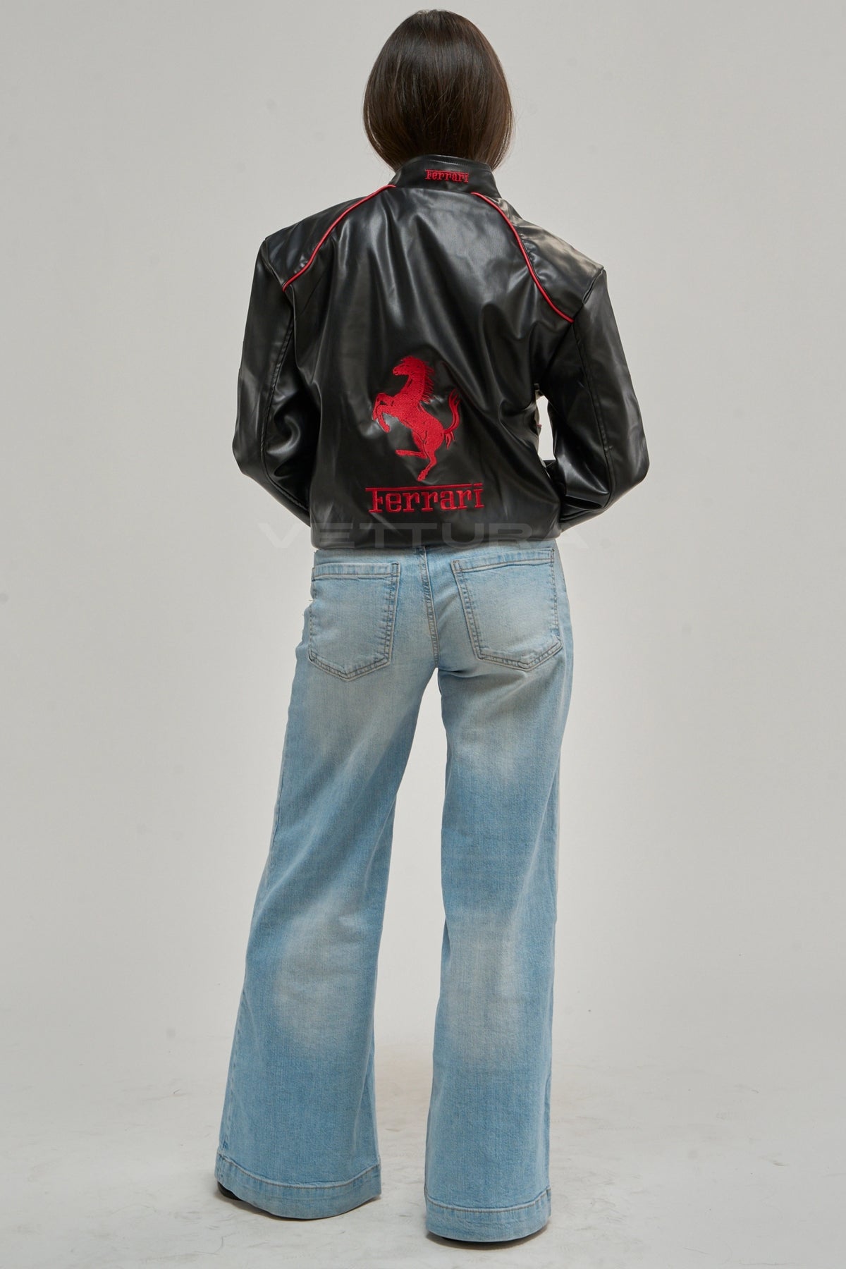 Ferrari F1 leather jacket white edition on a model, showing the embroidered sponsor patches