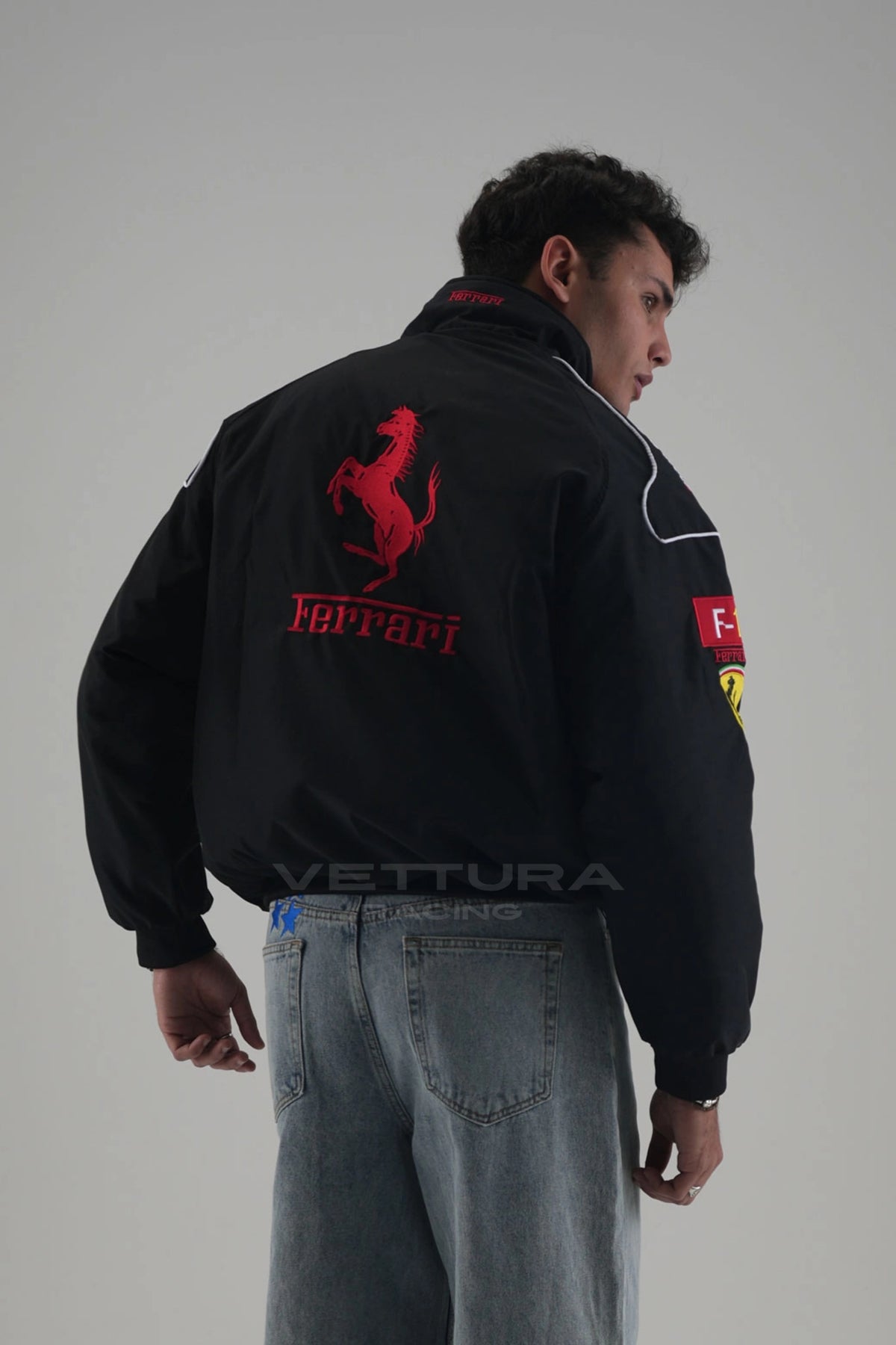 Back of the black Ferrari F1 vintage racing jacket with the embroidered red Prancing Horse