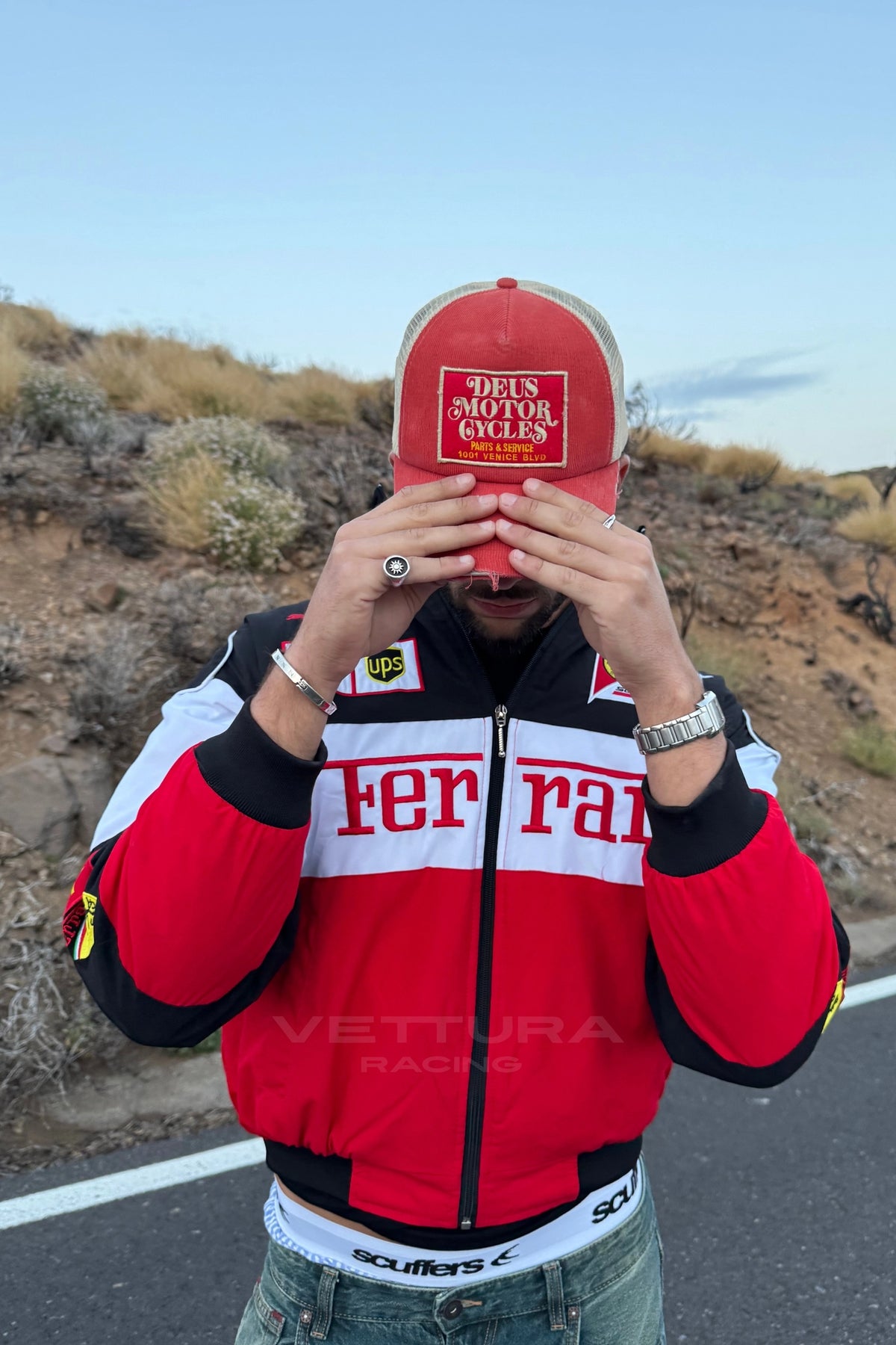 Ferrari F1 classic bomber jacket worn casually, embroidered sponsor patches visible