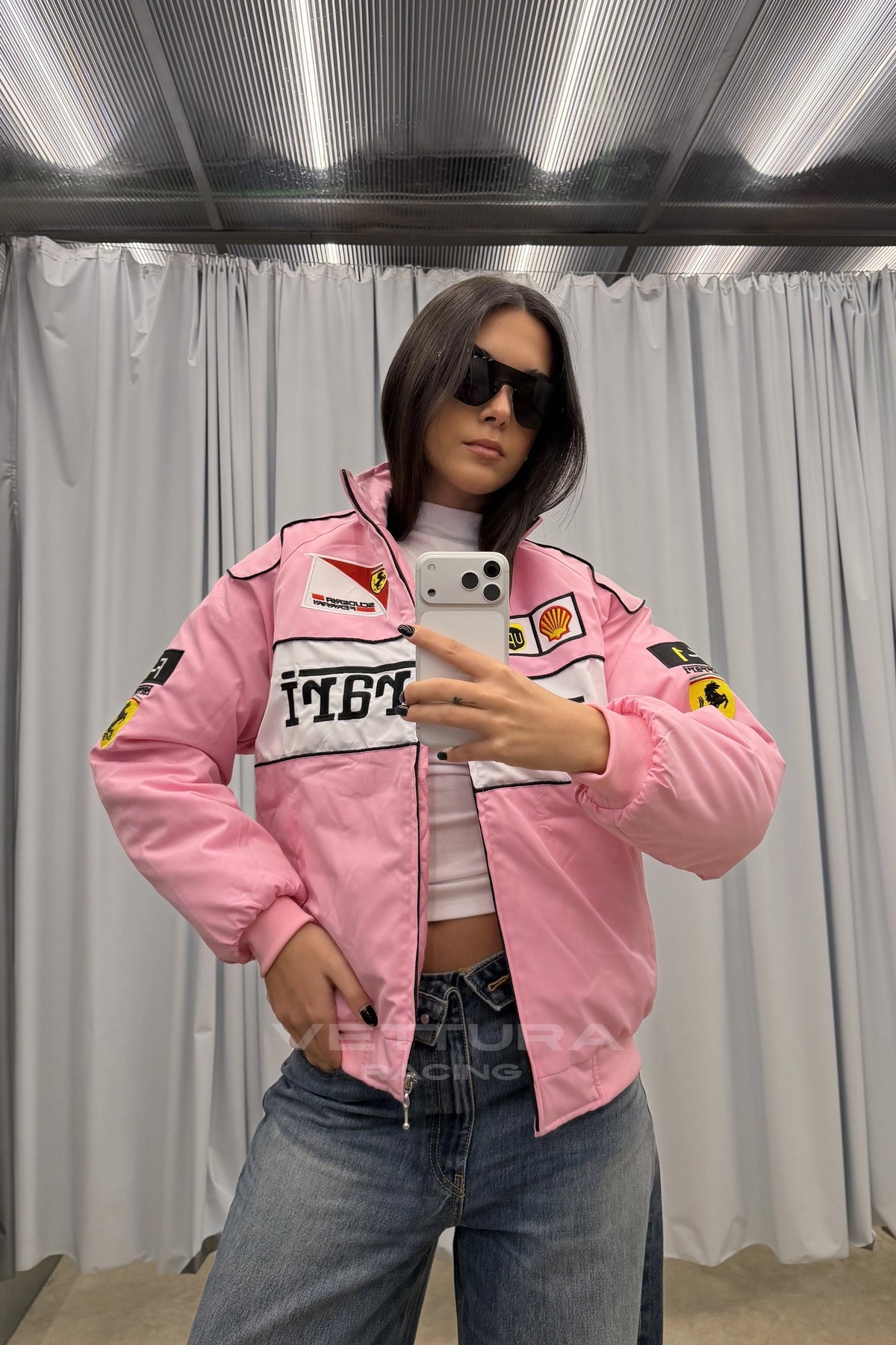 Close view of the Shell and UPS patches on the pink Ferrari jacket