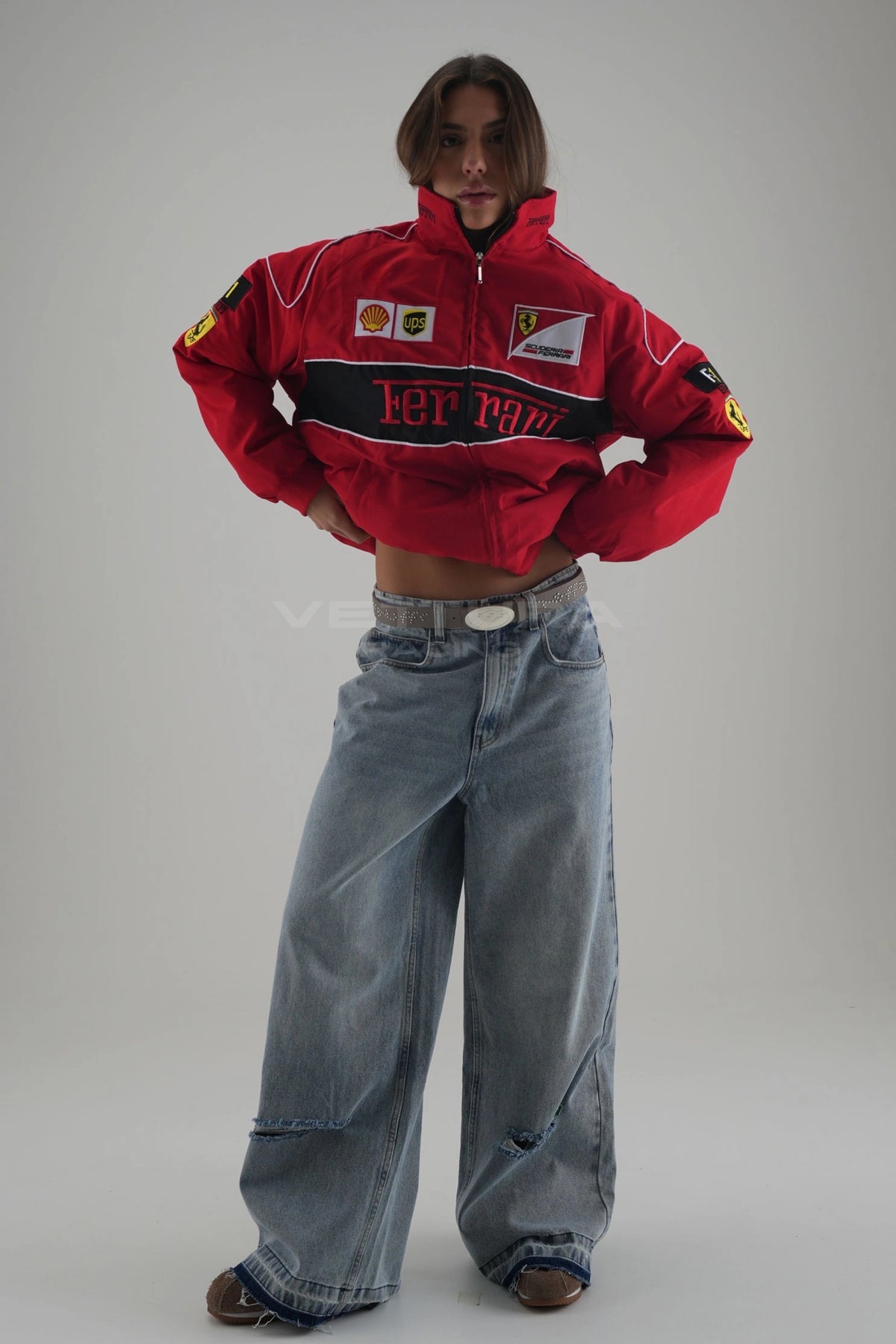 Ferrari F1 red racing jacket worn by a model, side view with black contrast shoulders