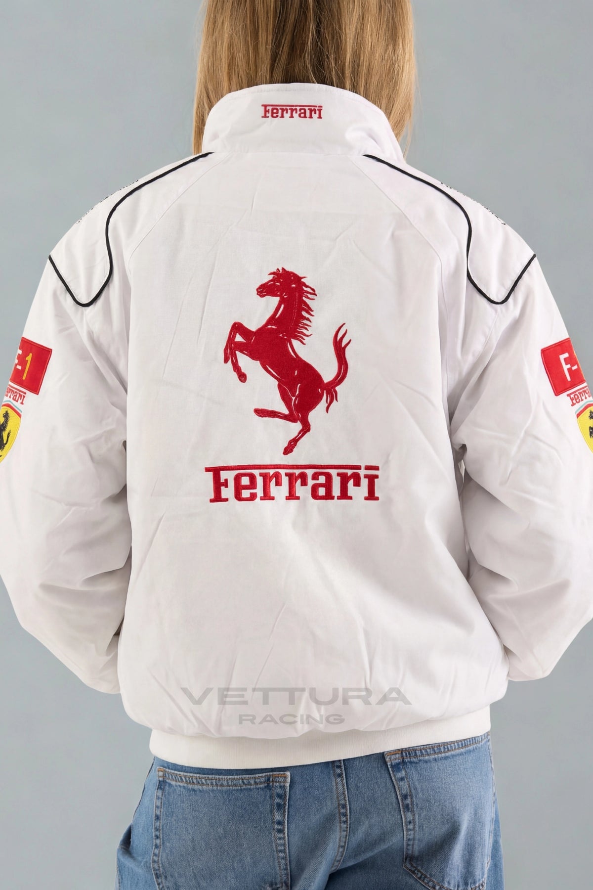 Close view of the embroidered Shell and F-1 patches on the Ferrari F1 white jacket