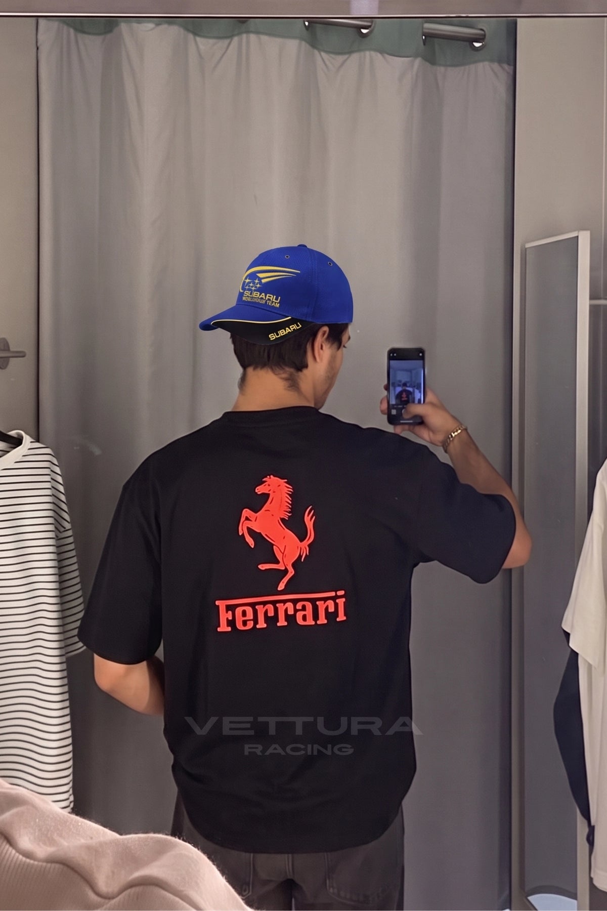 Detail of the red Ferrari script on the black F1 racing t-shirt