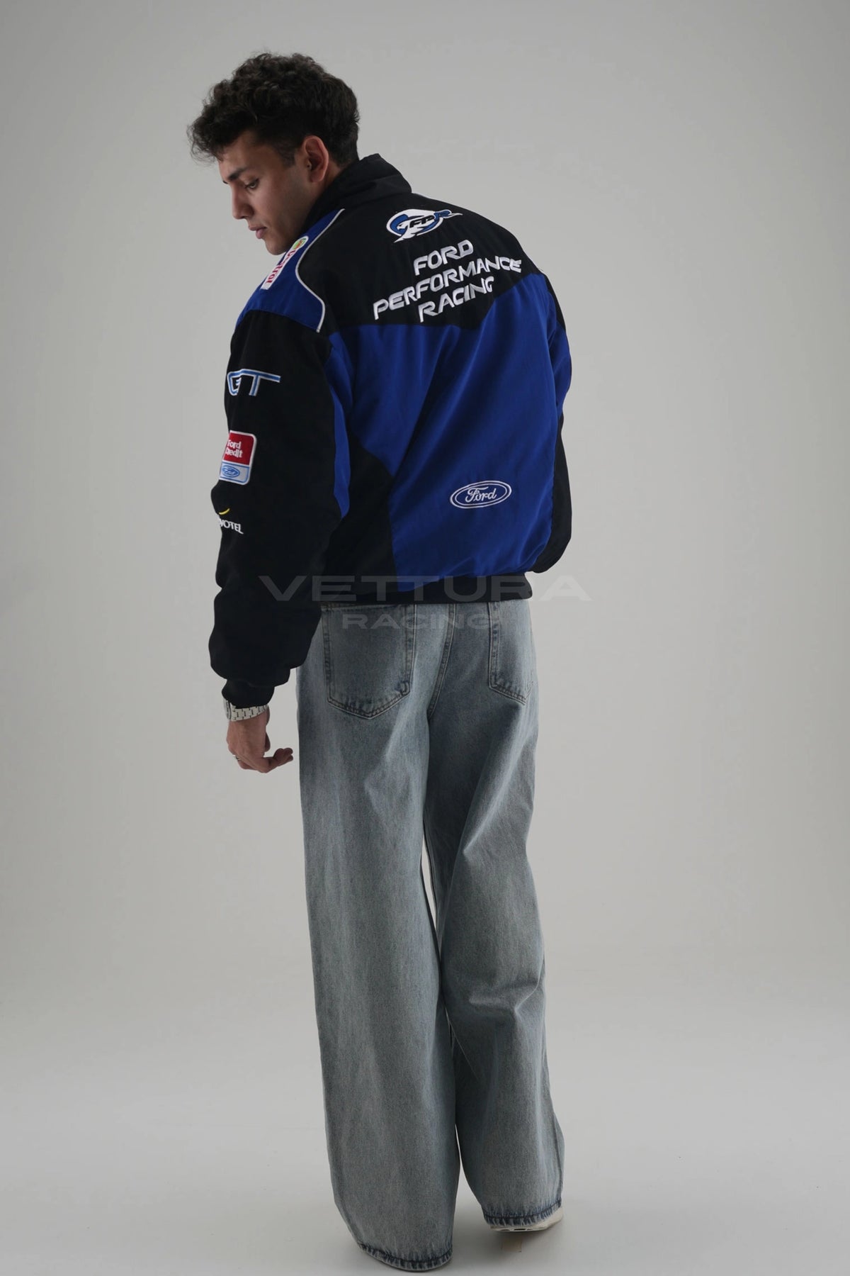 Back of the black and blue Ford Performance Racing jacket on a model