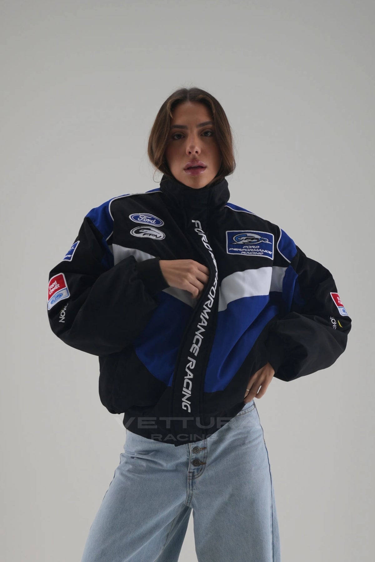 Rear view of the Ford Performance Racing bomber worn with wide leg jeans