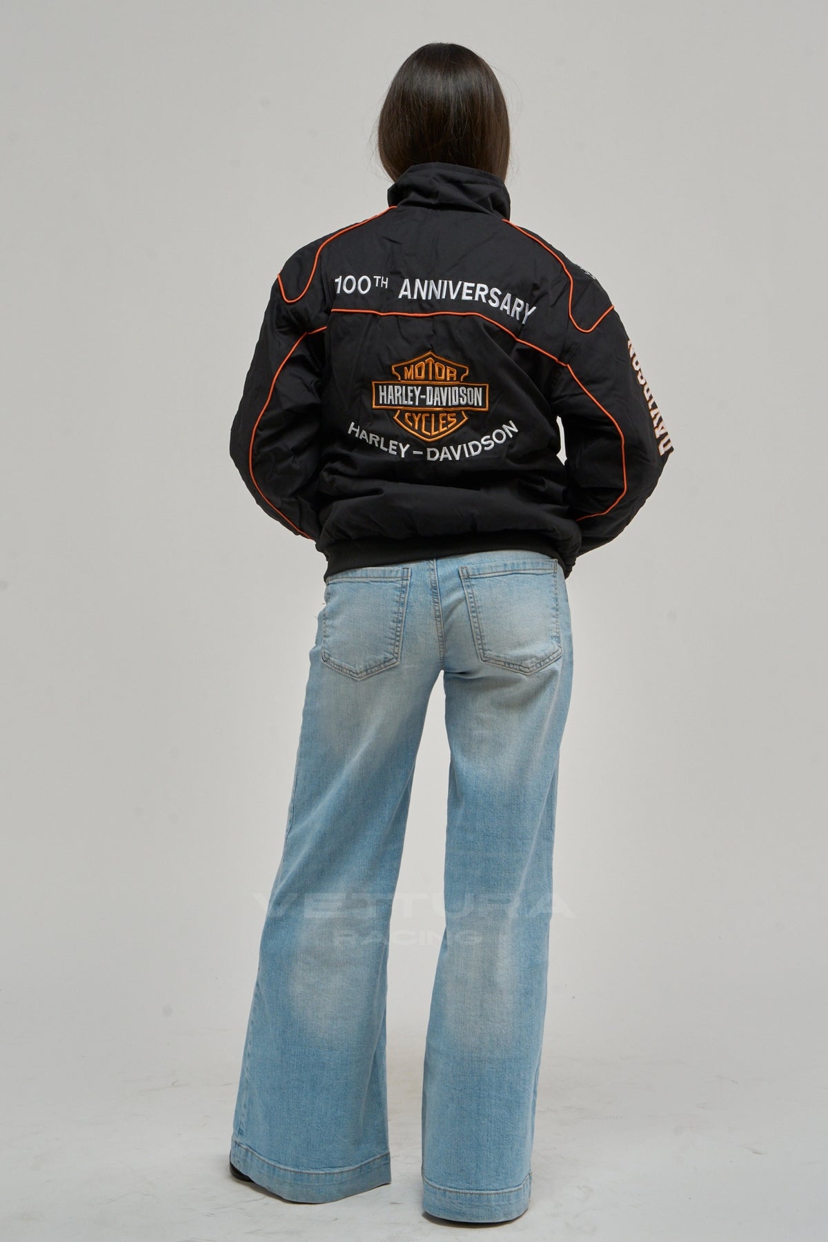 Rear view of the Harley Davidson vintage jacket worn with wide leg jeans