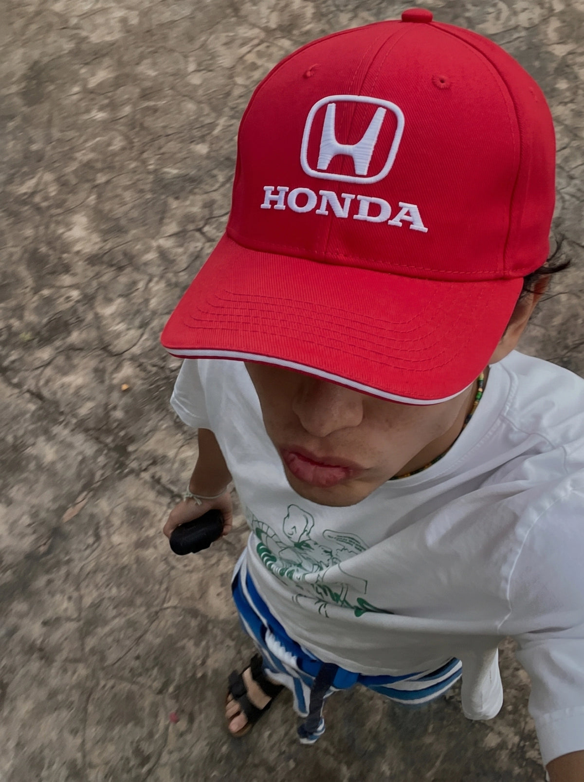 Red Honda Classic cap worn in the sun