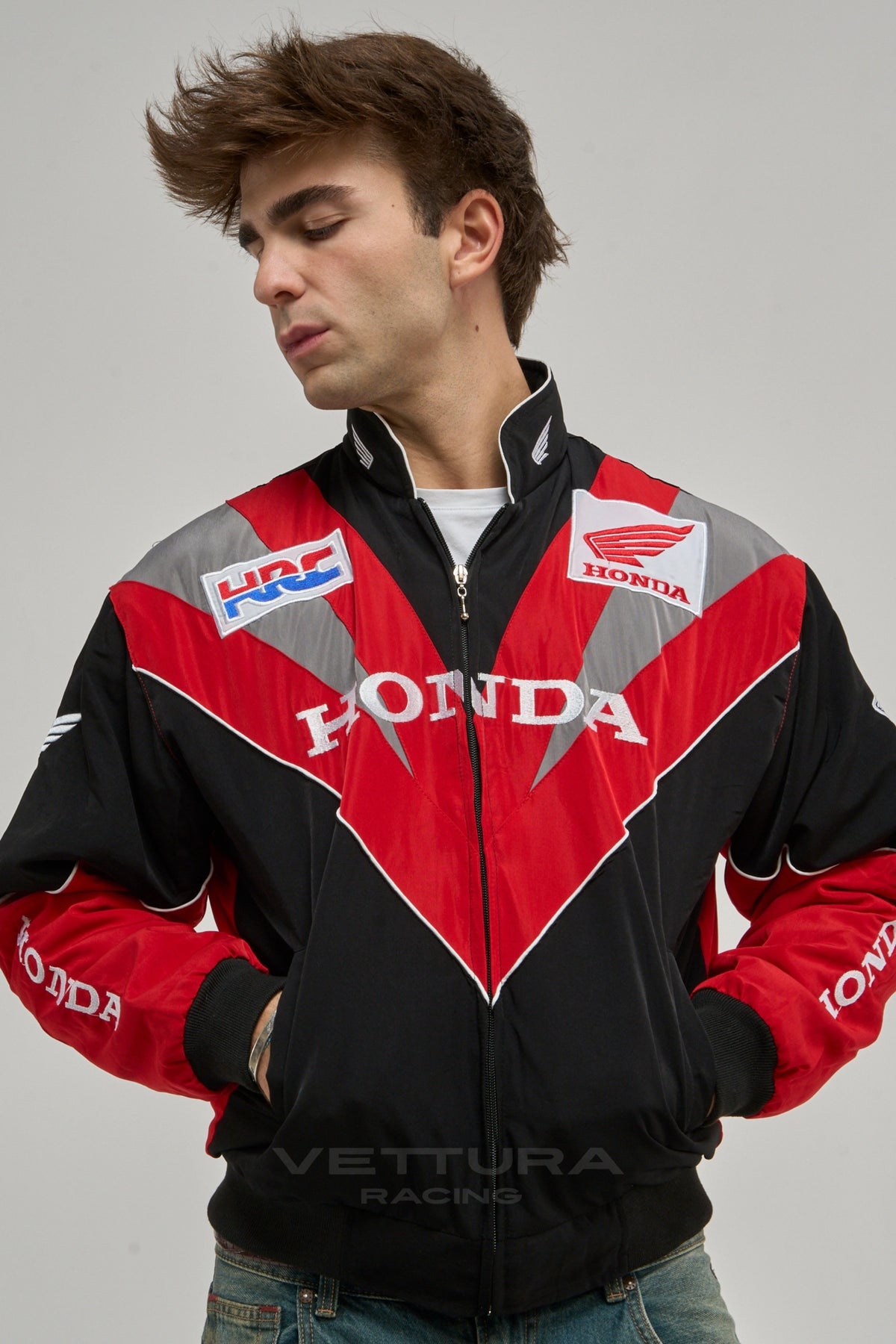Honda racing jacket styled with jeans in daylight