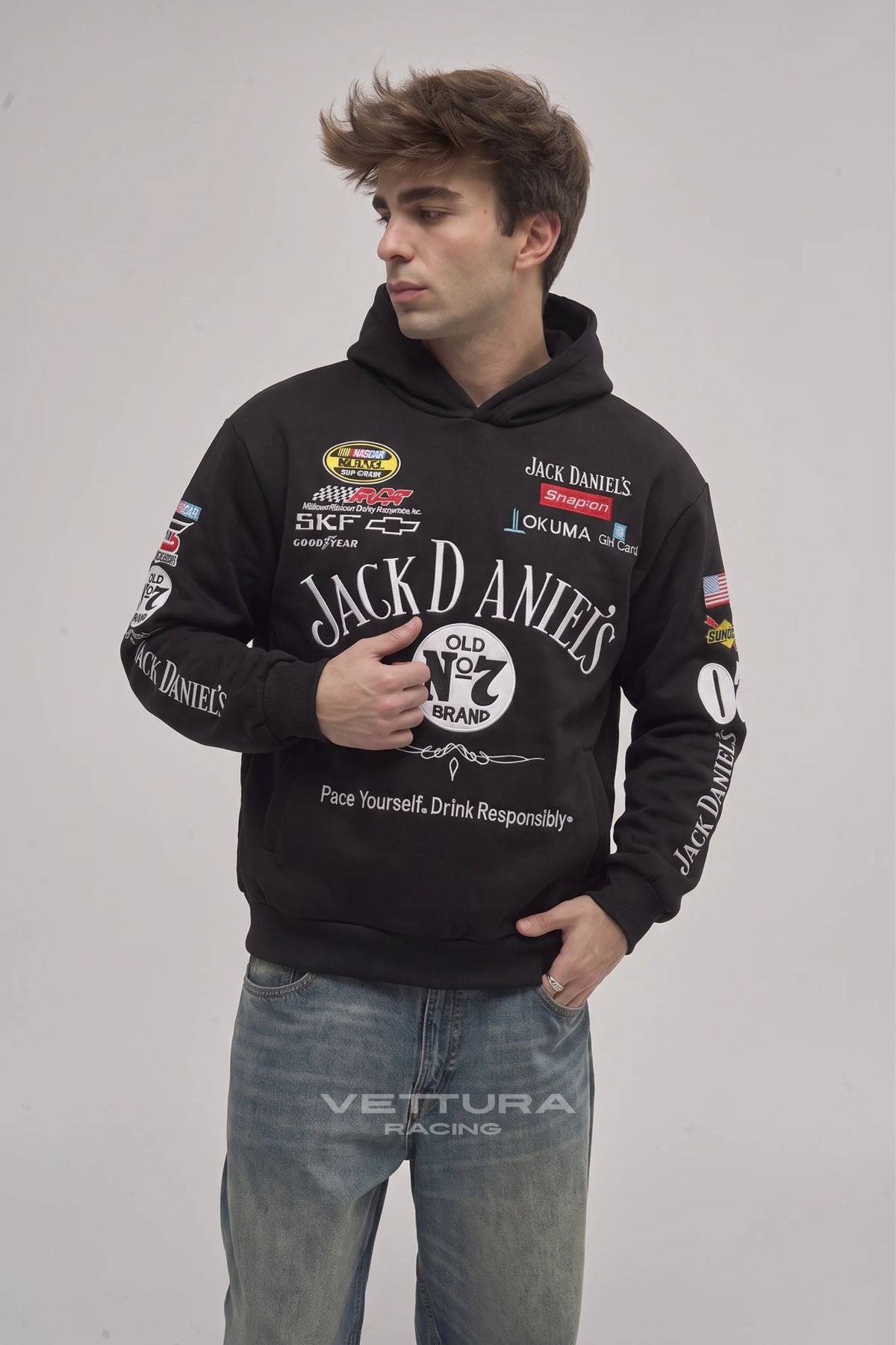 Man wearing the Jack Daniel’s racing hoodie in black, front view with the embroidered Old No.7 label