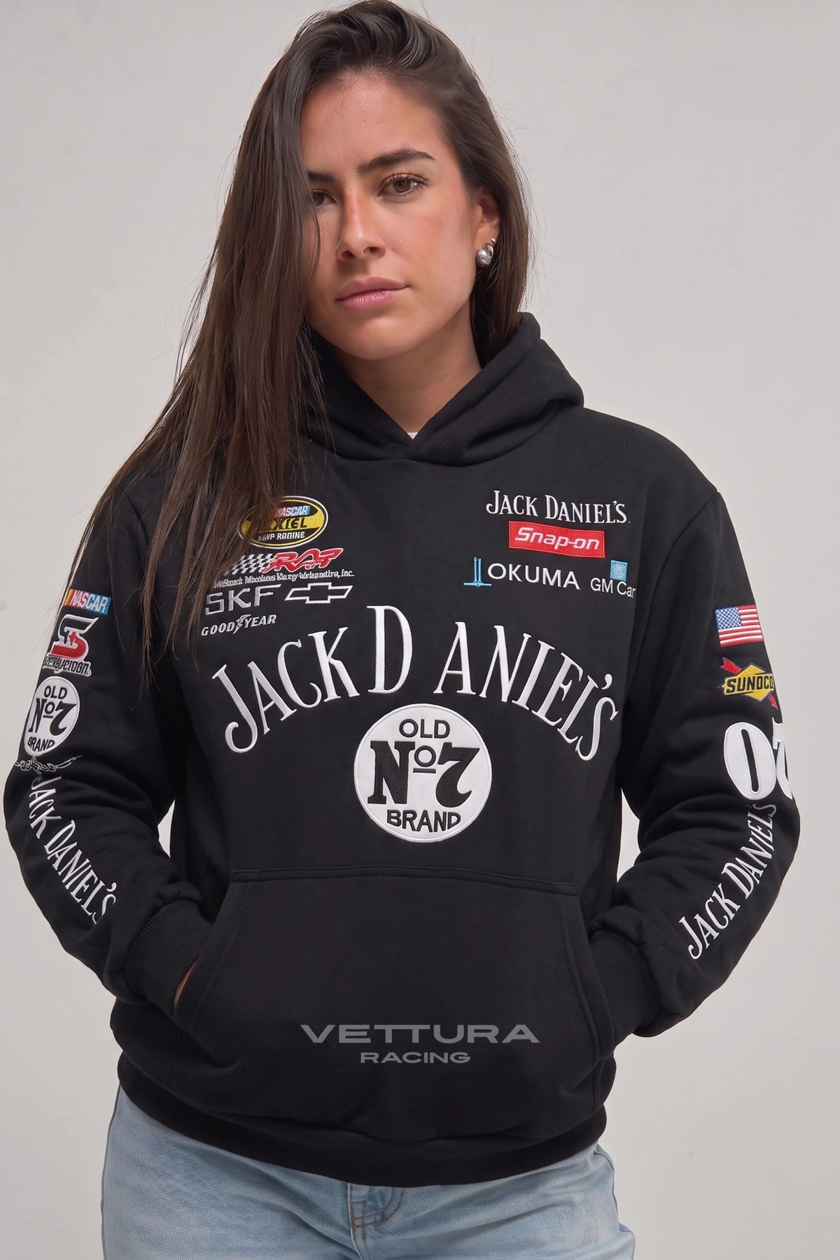 Woman wearing the Jack Daniel’s embroidered hoodie, front view with the Goodyear and SKF patches