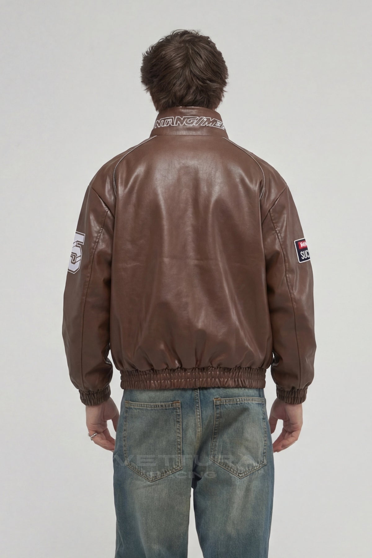 Model wearing the LAP 85 brown racing bomber jacket, front view