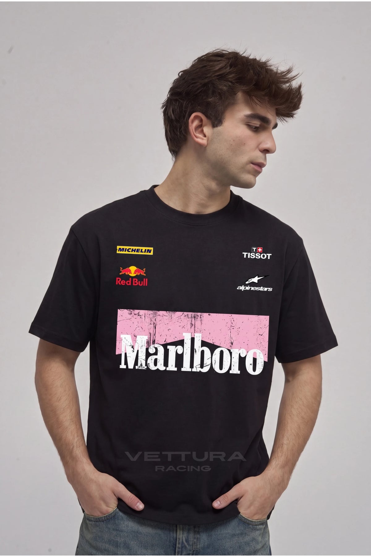 Man wearing the Marlboro racing t-shirt pink edition, front view with the Michelin, Red Bull and Tissot chest prints