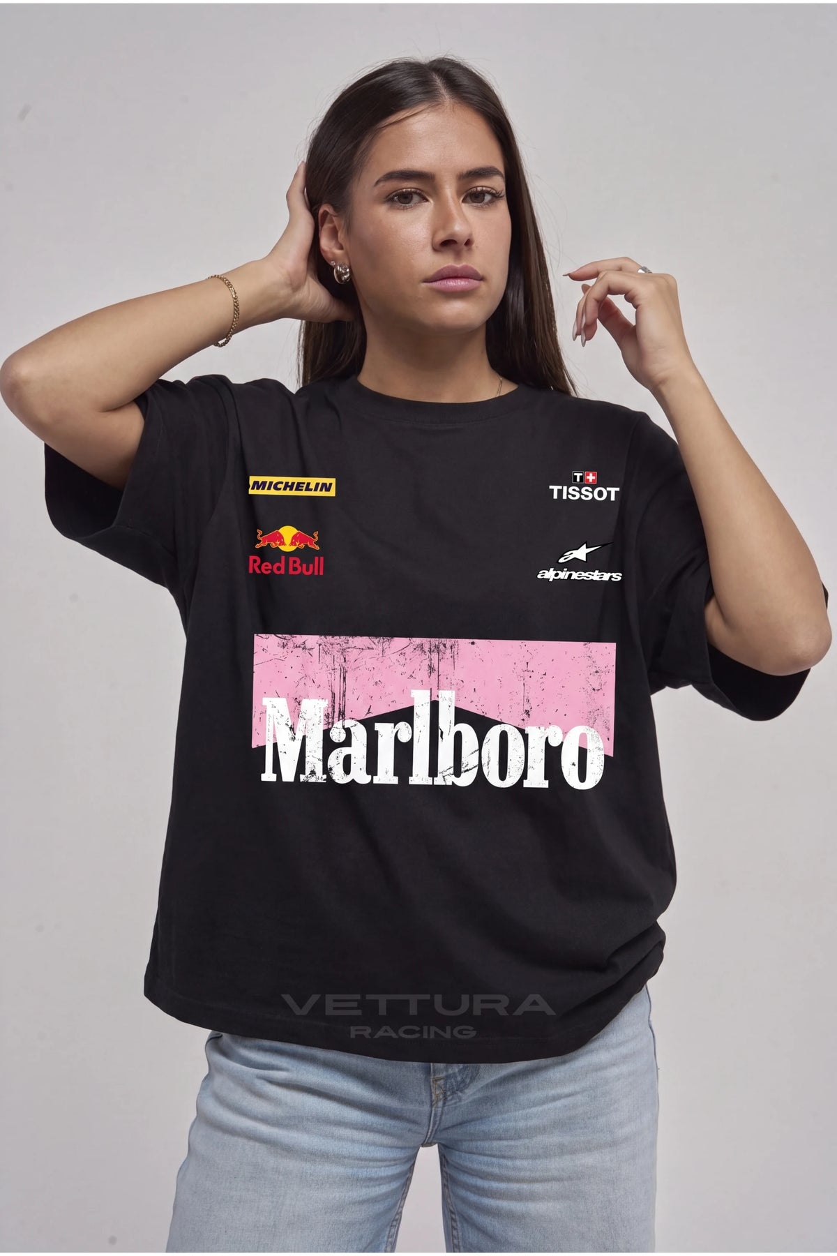 Woman wearing the Marlboro racing t-shirt pink edition, front view with the sponsor prints