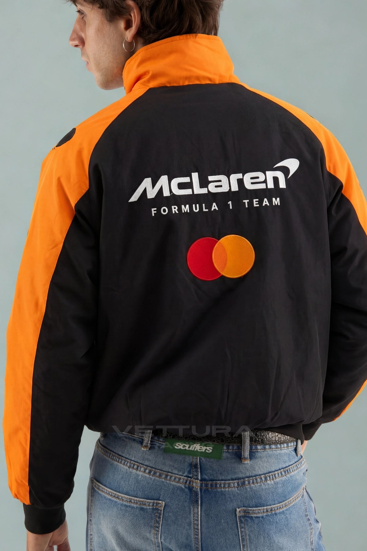 McLaren F1 racing jacket in orange and black styled with jeans