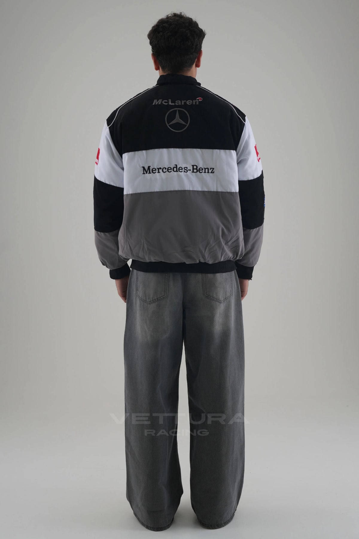 Back of the grey and black McLaren Mercedes vintage F1 racing jacket on a model