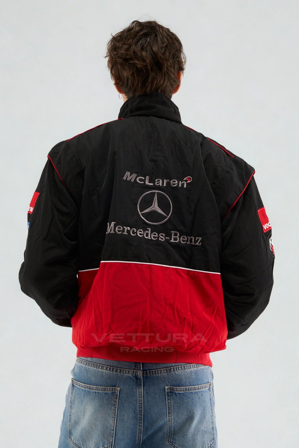 Back of the black and red McLaren Mercedes vintage F1 jacket on a model