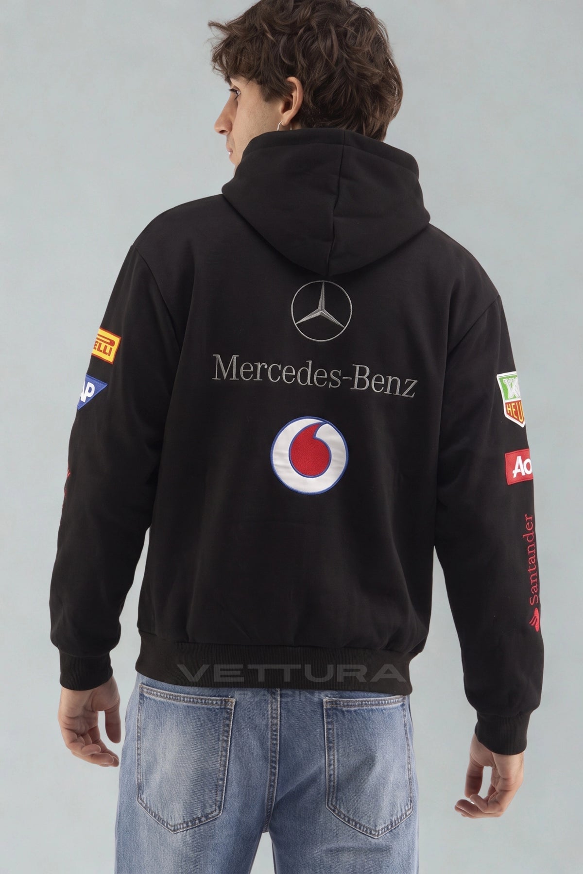Close view of the embroidered Vodafone and Mobil 1 patches on the Mercedes hoodie