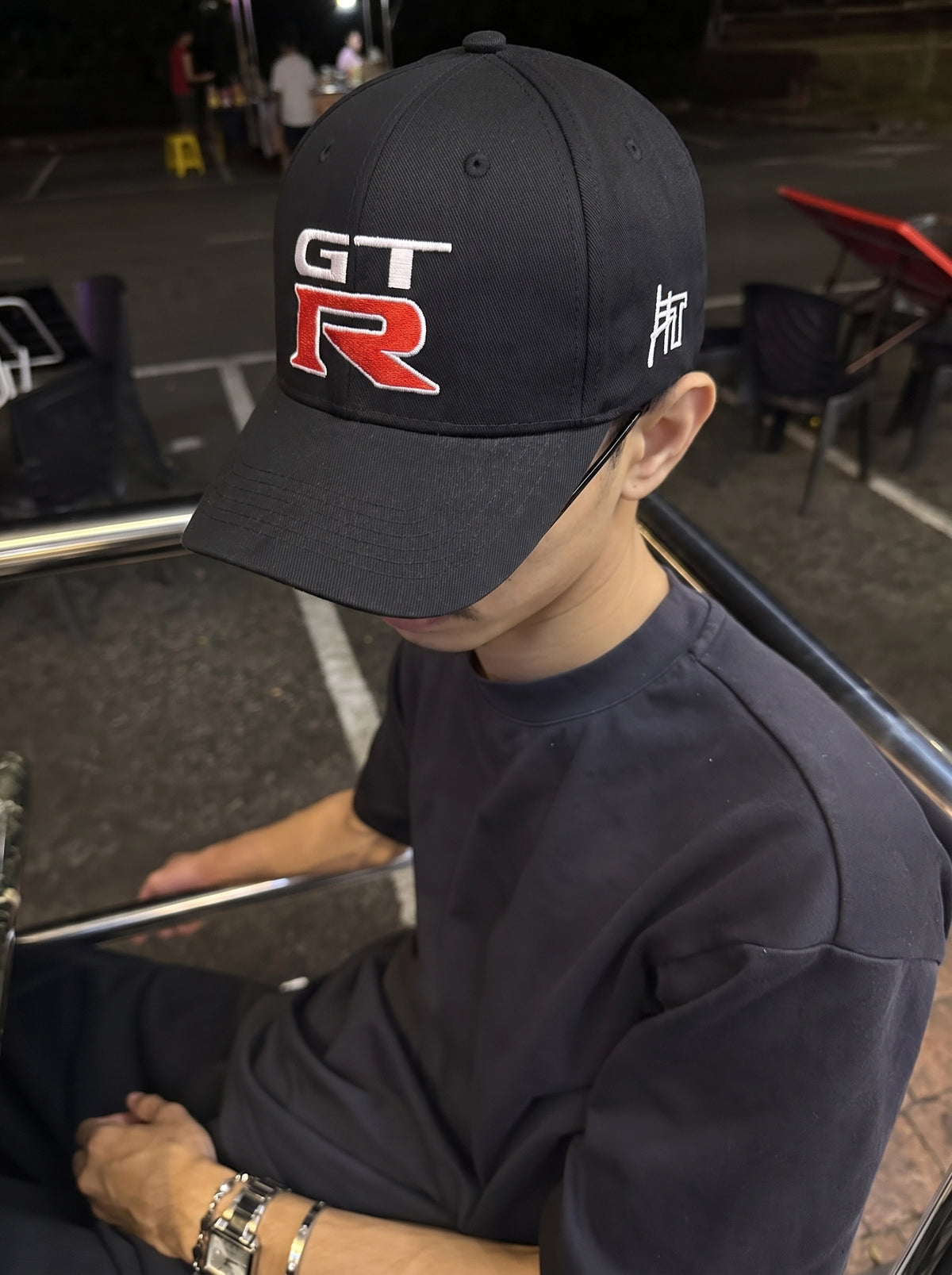 Model wearing the black Nissan GT-R Nismo cap