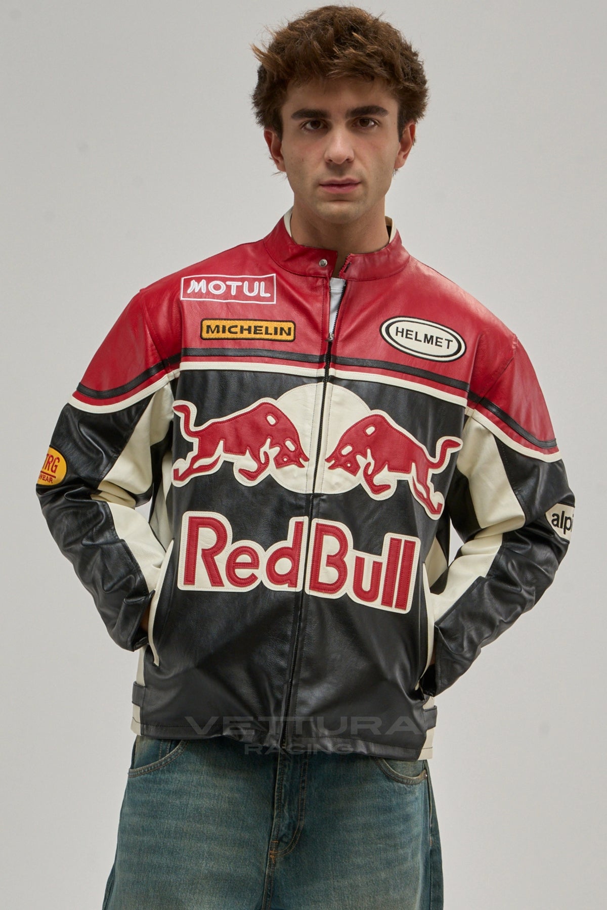 Model wearing the red, black and grey Red Bull racing leather jacket, front view