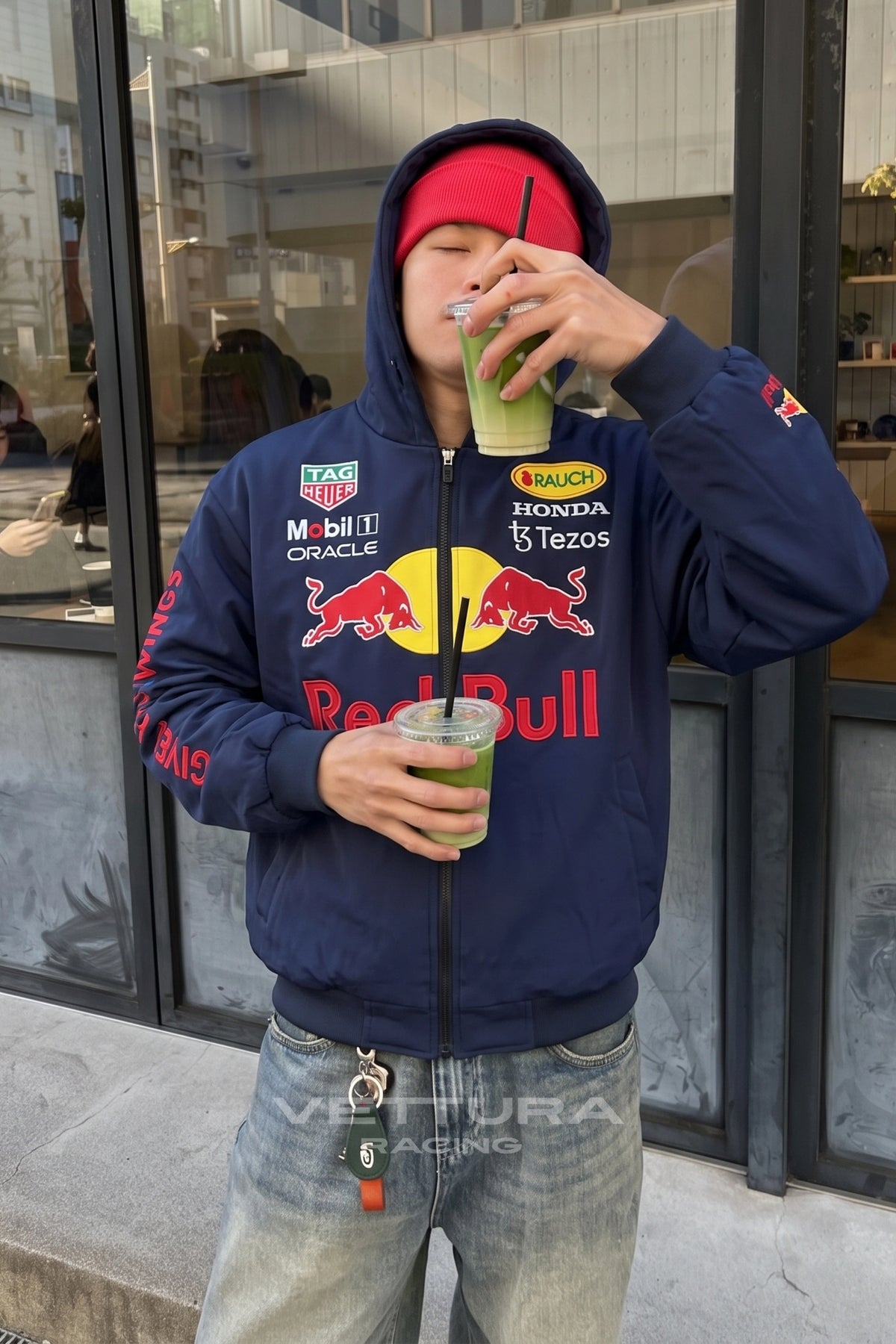 Close view of the embroidered Oracle and Honda patches on the Red Bull hoodie