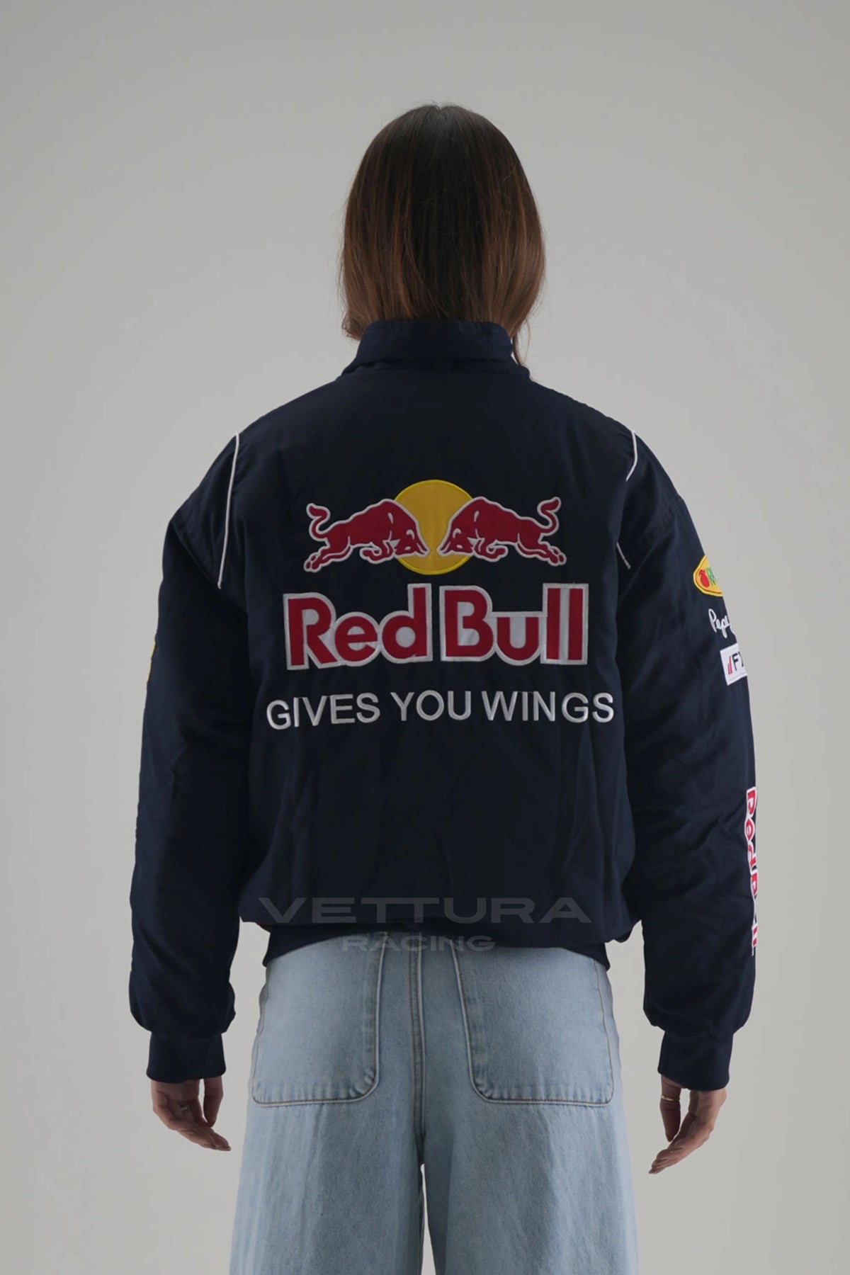 Rear view of the Red Bull F1 racing bomber worn with wide leg jeans