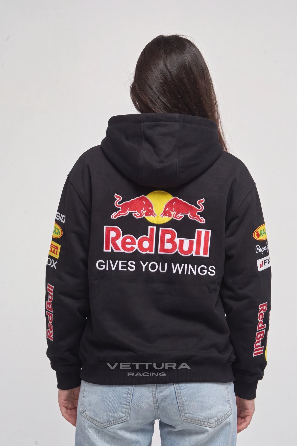 Woman wearing the Red Bull Racing F1 hoodie, back view with the stitched bulls and lettering