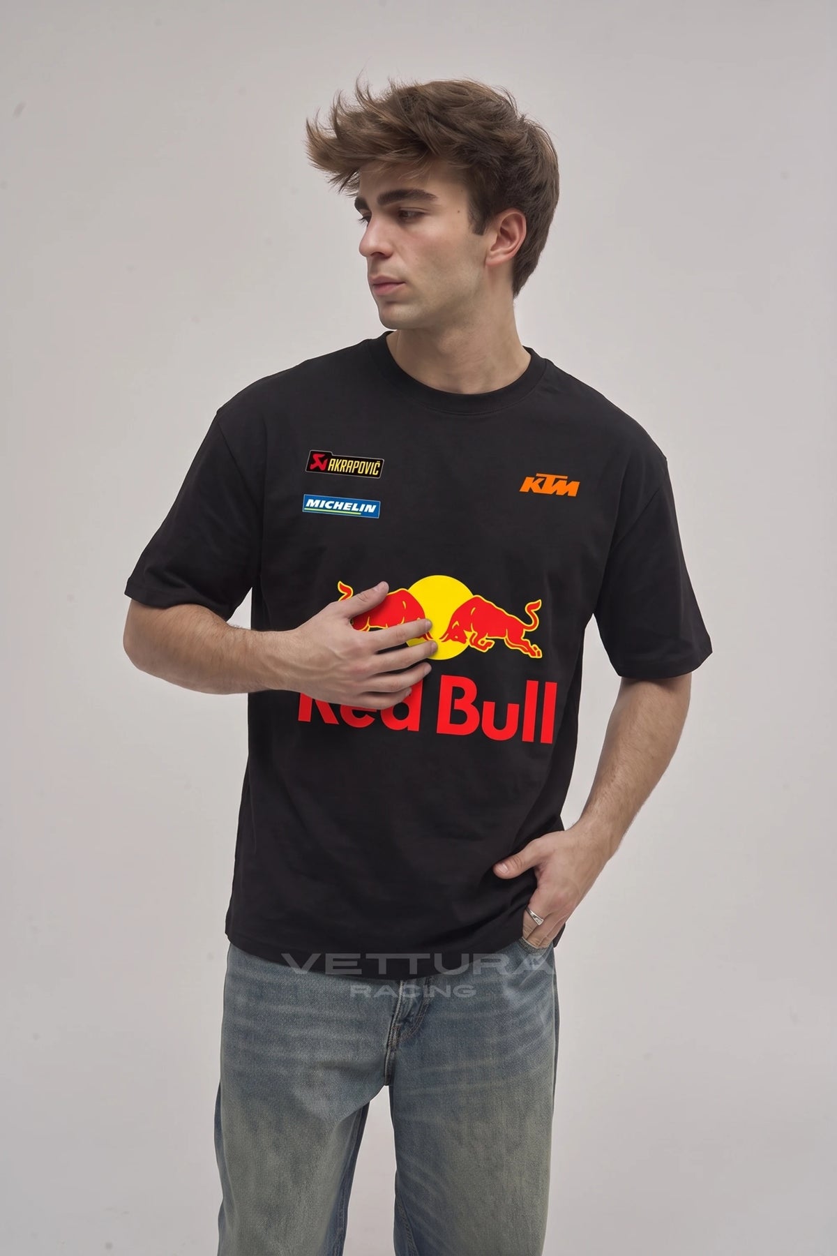 Man wearing the Red Bull racing t-shirt in black, front view with the red and yellow charging bulls