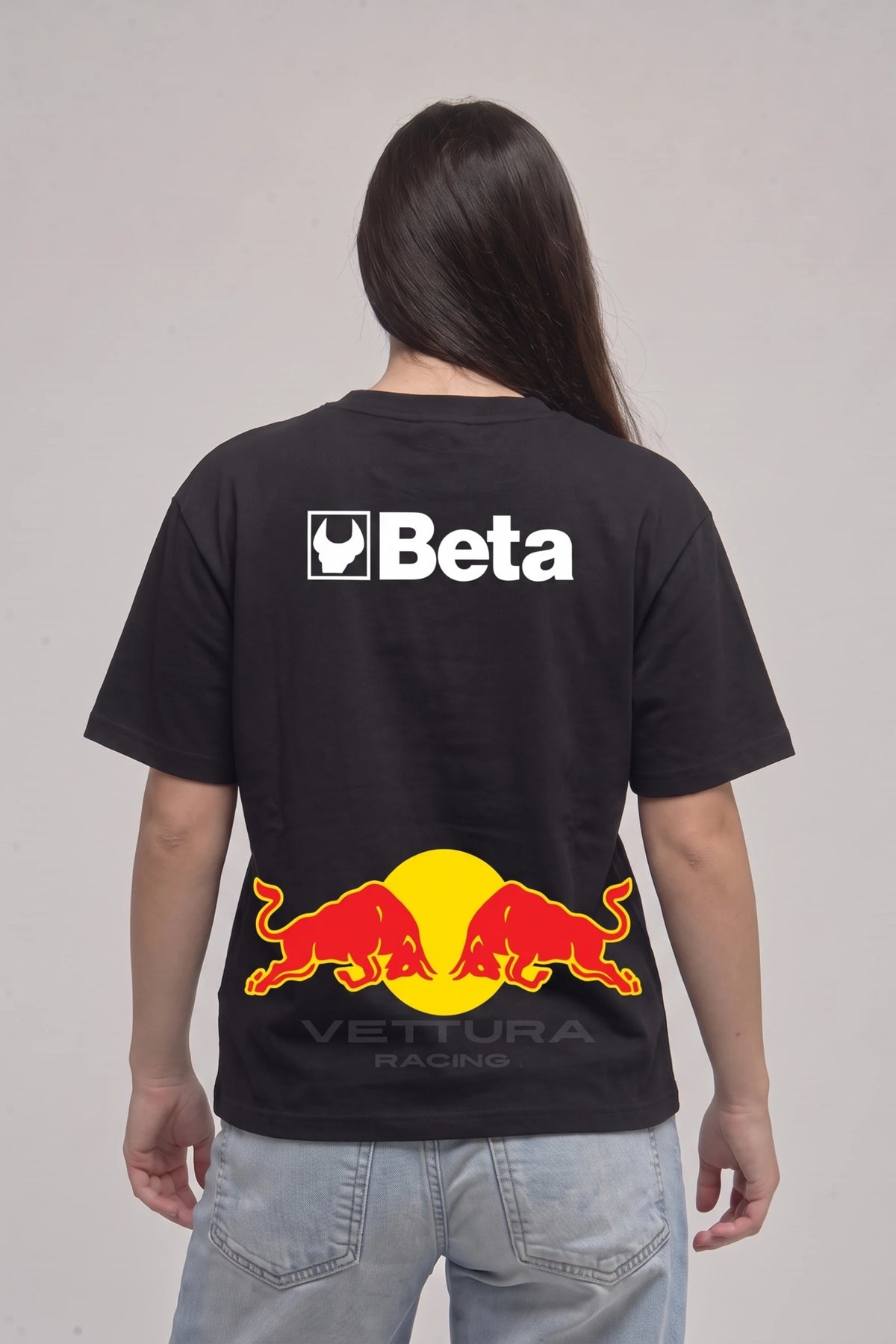 Woman wearing the Red Bull classic edition tee, back view with the Beta panel and charging bulls