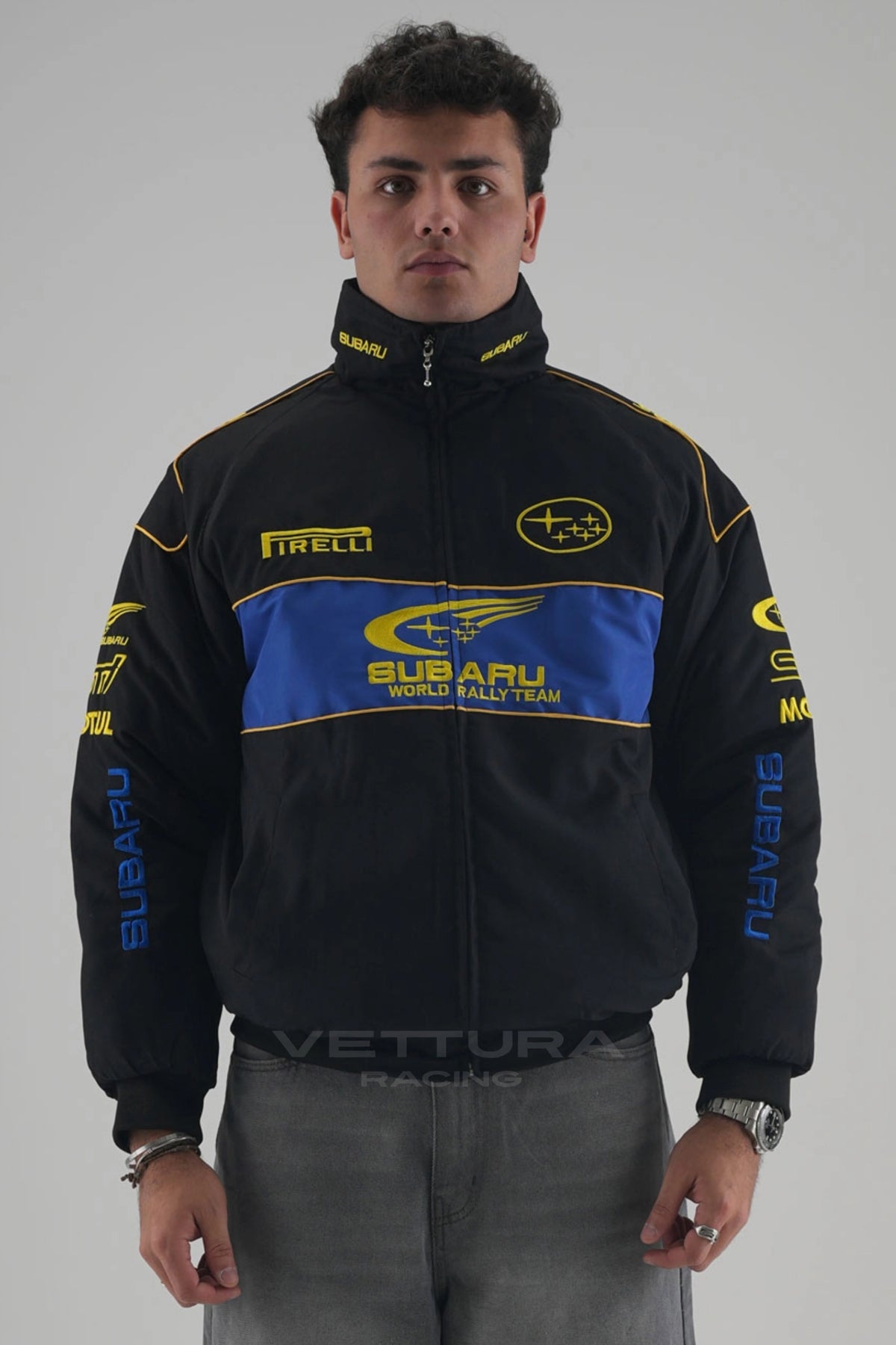 Model wearing the black Subaru World Rally vintage racing jacket, front view