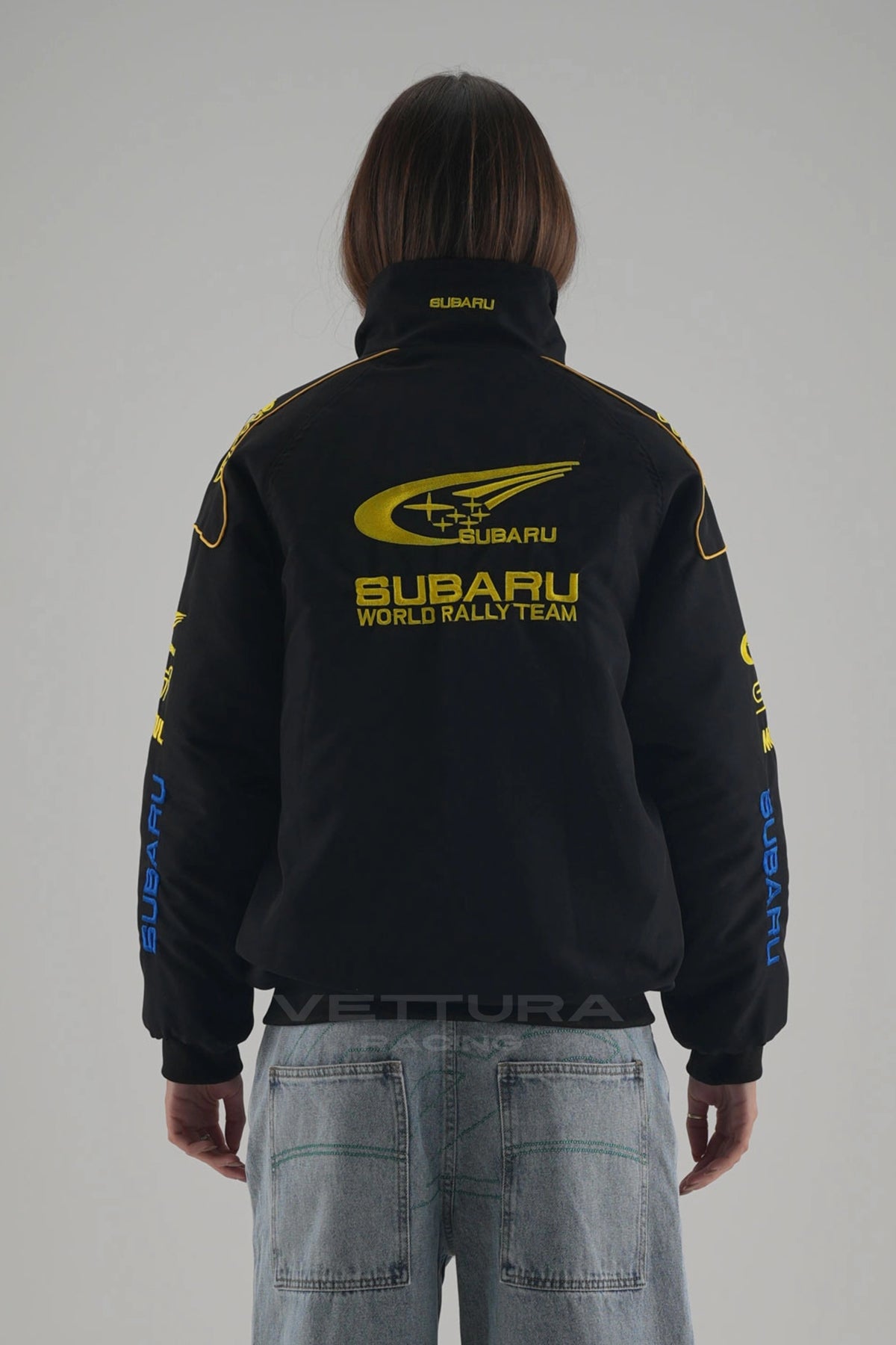 Woman wearing the black Subaru rally vintage racing jacket
