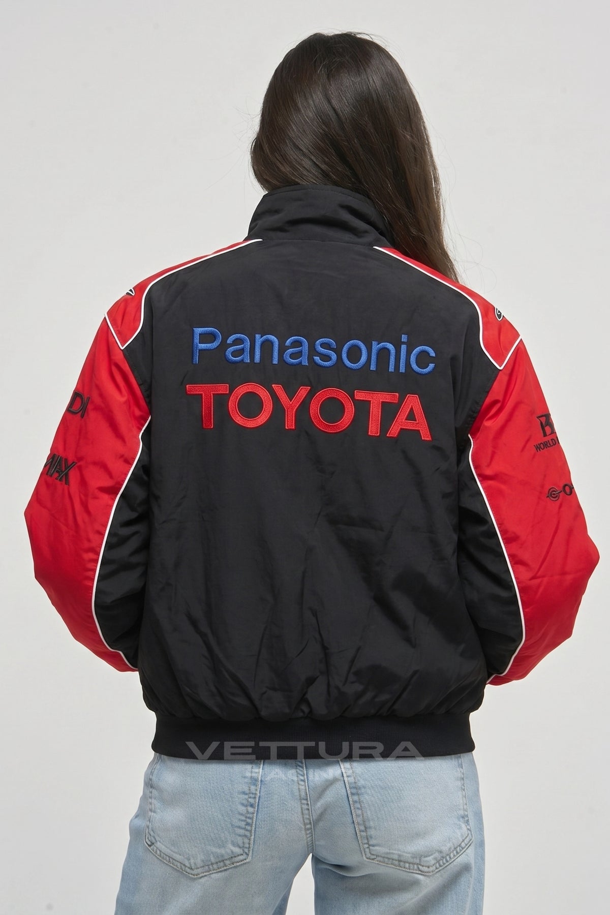 Model wearing the Toyota Panasonic black vintage racing jacket, front view