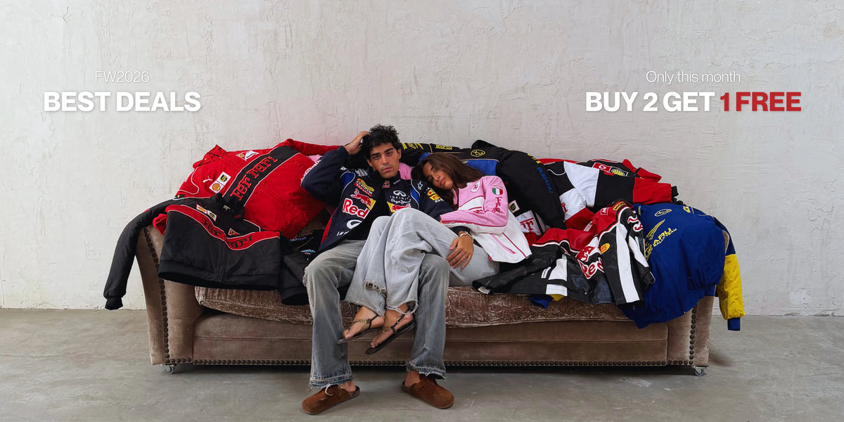 Best deals, buy 2 get 1 free: couple on a sofa piled with Ferrari, Red Bull and Subaru vintage racing jackets