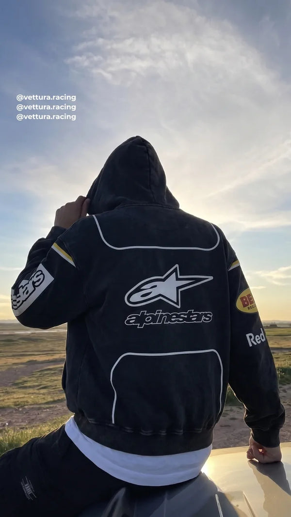 Back of a black Alpinestars racing jacket at sunset