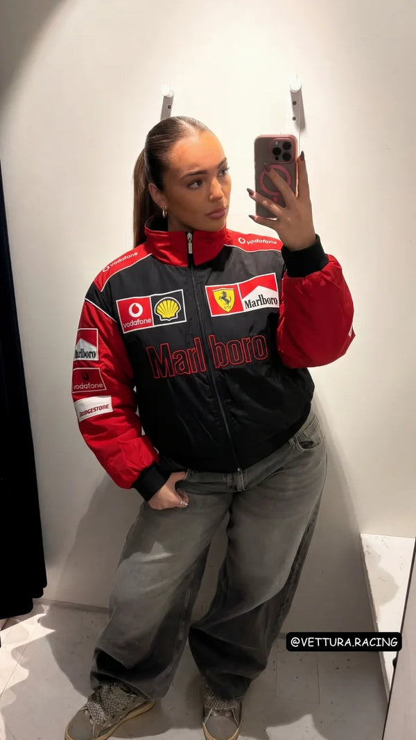 Customer mirror selfie in a black Ferrari Marlboro racing jacket