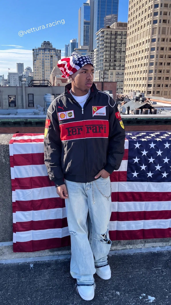 Customer in a navy Ferrari racing jacket in front of a US flag