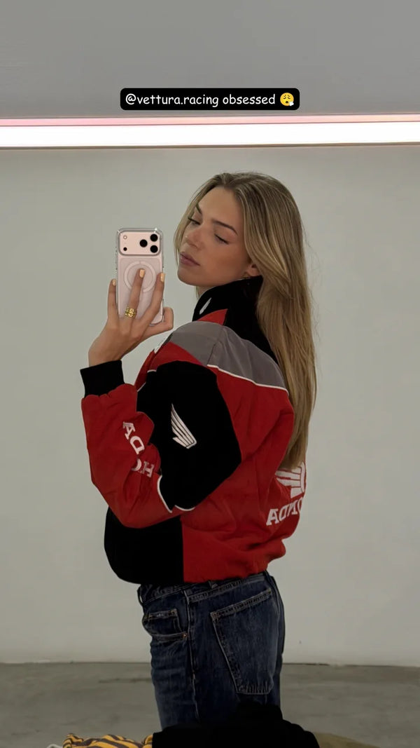 Customer mirror selfie in a red and black Honda racing jacket