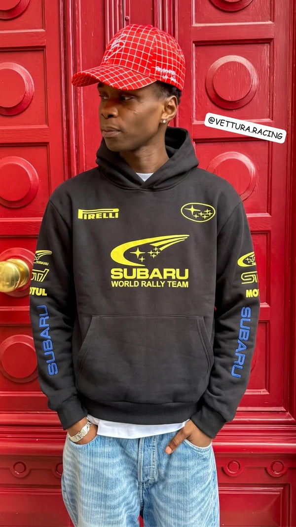 Customer in a black Subaru World Rally Team hoodie