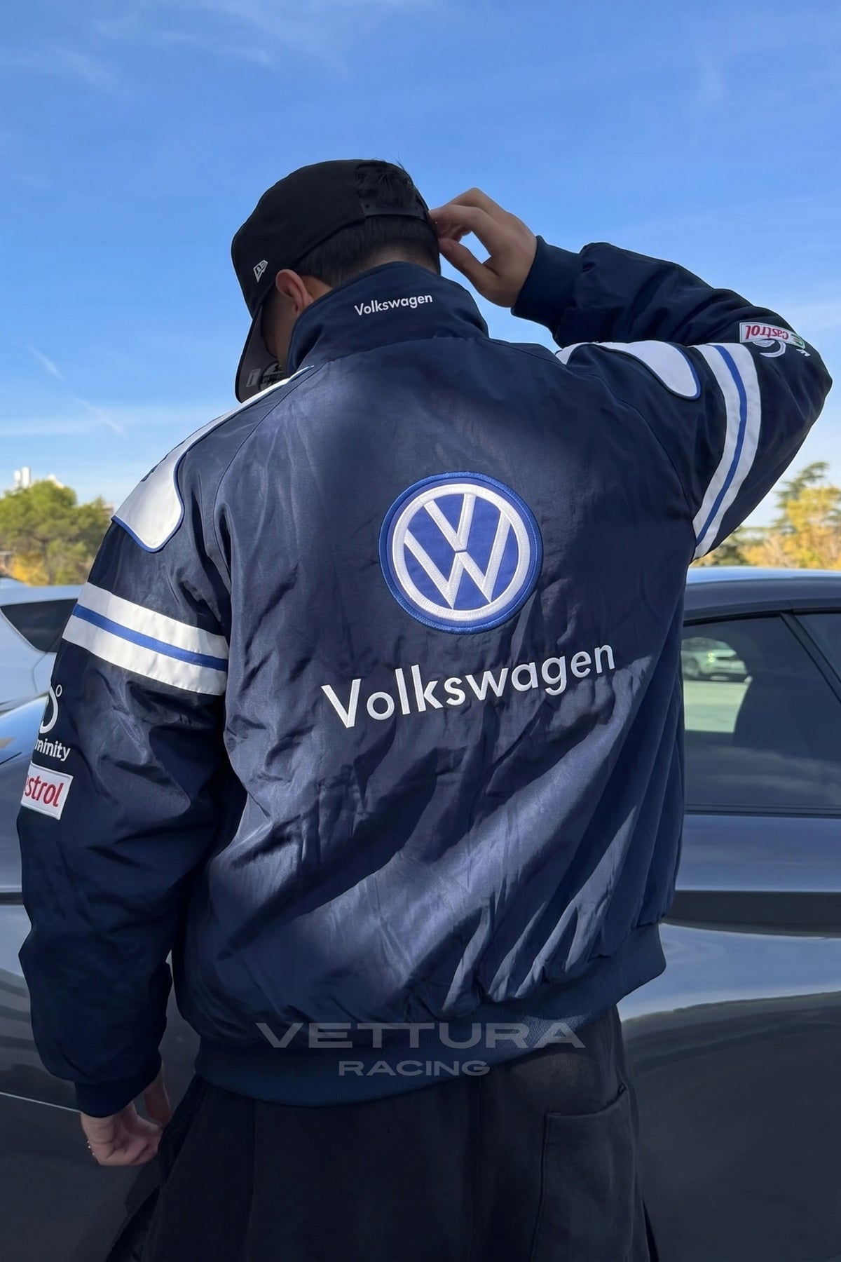Close view of the Volkswagen roundel on the navy racing jacket